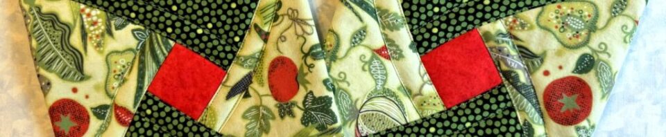 Fabric pieces in green and red patterns.