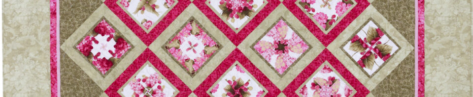 Colorful quilt with floral diamond patterns.