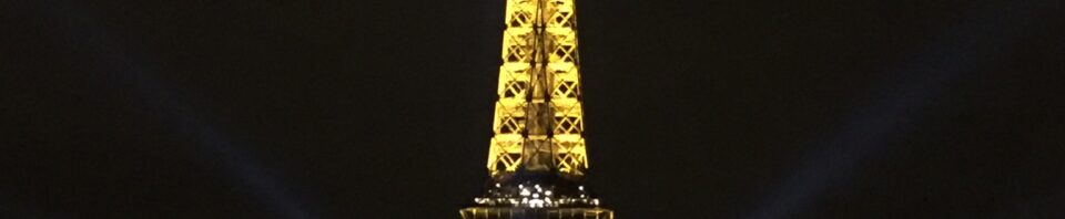 Eiffel Tower illuminated at night in Paris.