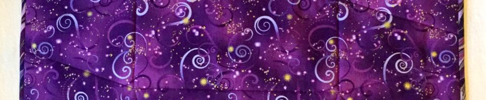 Purple fabric mat with swirl patterns.