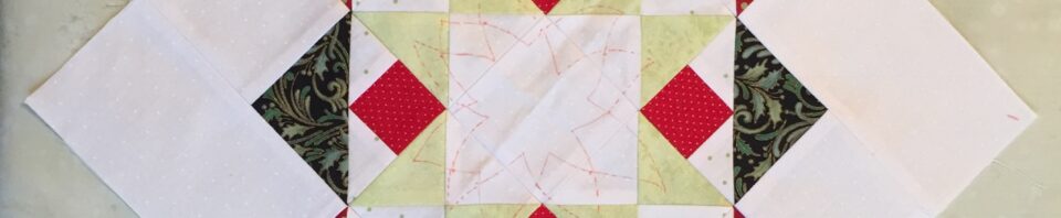 Colorful quilt block with geometric patterns.