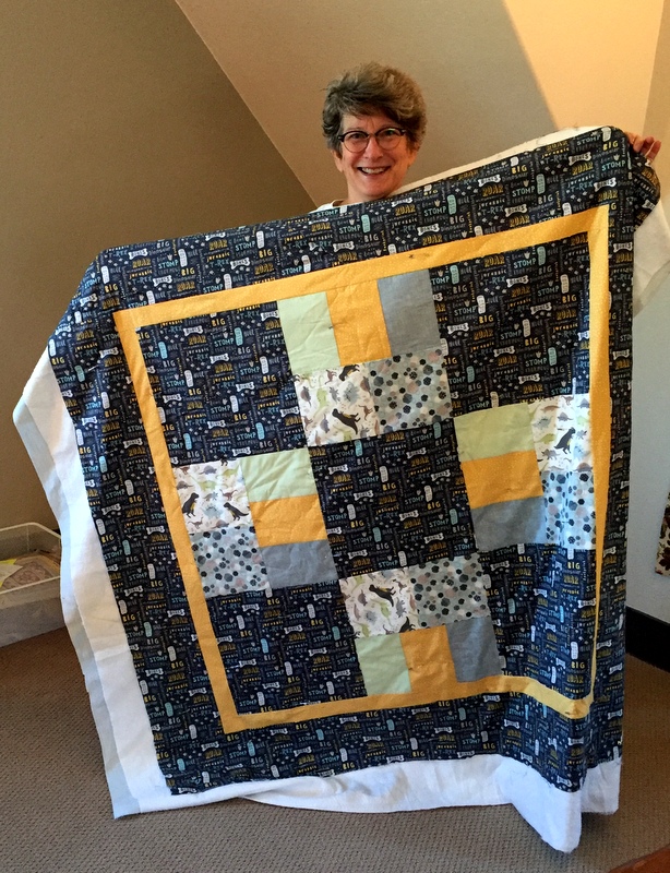 https://firstlightdesigns.com/wp-content/uploads/2018/07/Deborah-with-Just-Cant-Cut-It-baby-quilt.jpg