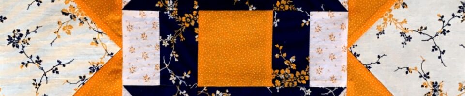 Floral and geometric patterned quilt block.