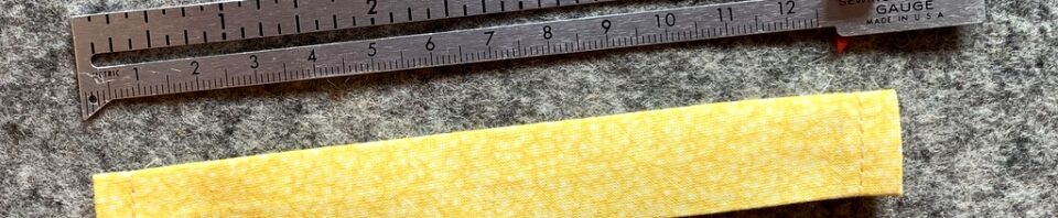 Yellow fabric strip beside a measuring gauge.