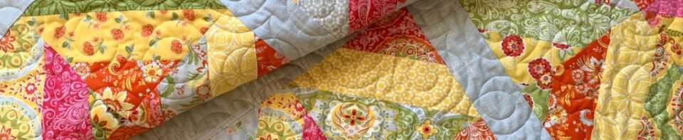 Colorful patchwork quilt with floral patterns.