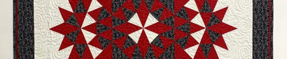 Red and black star-patterned quilt design.