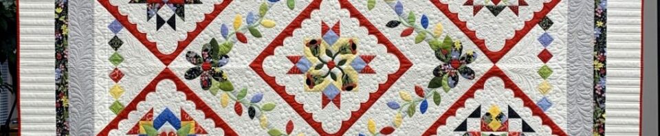 Colorful quilt with geometric patterns and flowers.