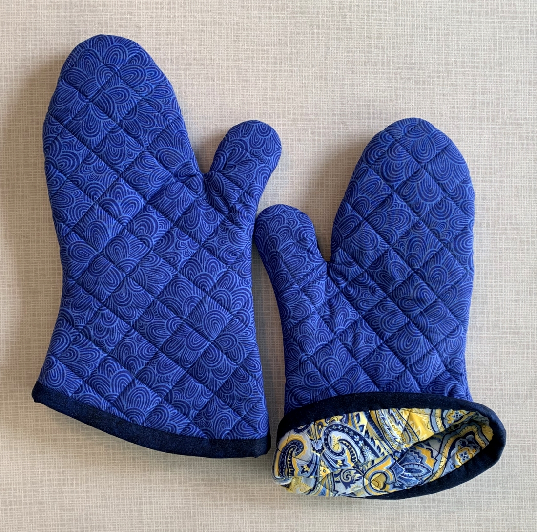 https://firstlightdesigns.com/wp-content/uploads/2022/03/oven-mitts-for-tracy-showing-lining.jpg
