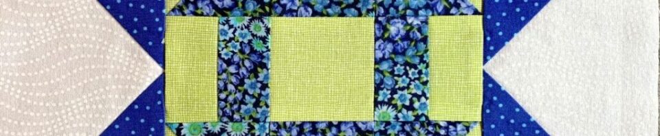 Colorful quilt block with floral patterns.