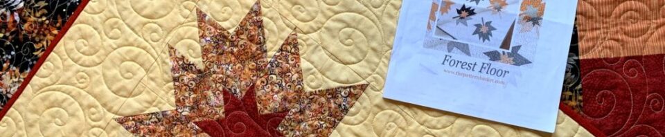 Autumn quilt with leaf patterns and instructions.