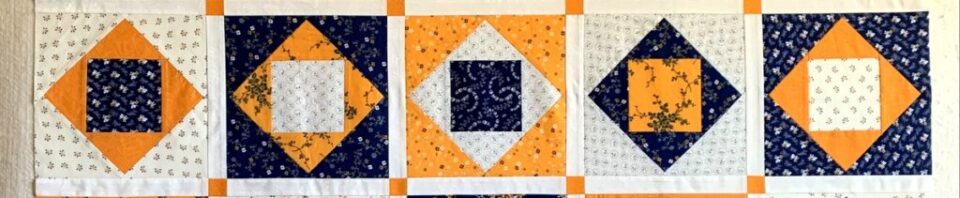 Colorful quilt squares in orange and navy.