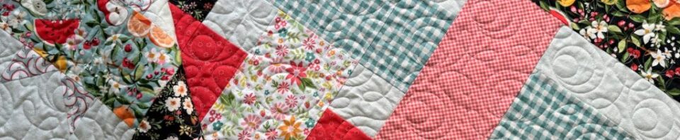 Colorful quilt with floral and checkered patterns.